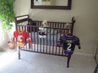 HERE'S THE CRIB ALL SET UP AND READY FOR THE LITTLE GUY. HIS JERSEYS ARE READY AS SOON AS HE GROWS INTO THEM!