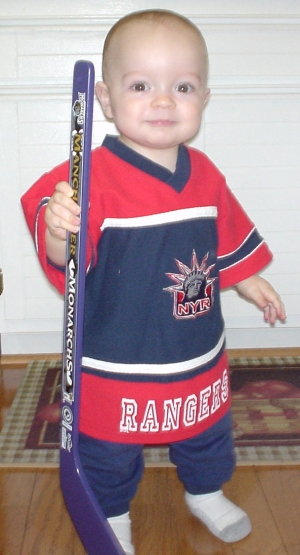 Nate in the kitchen with his Manchester Monarchs hockey stick and the New York Rangers shirt we got on eBay.